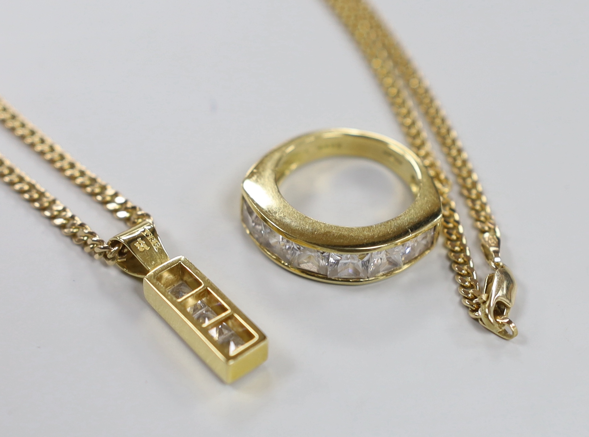 A modern 18ct gold and six stone cubic zirconia set half hoop dress ring, size P, gross weight 12.6 grams and a similar pendant, gross 4.3 grams, on a 9ct gold chain, 11 grams.